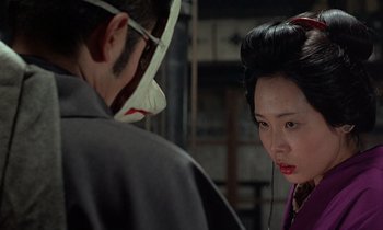 Movie still from “In the Realm of the Senses” (1976), directed by Nagisa Ôshima – A man and a woman in traditional japanese clothing; Close Up shot, Over the shoulder angle