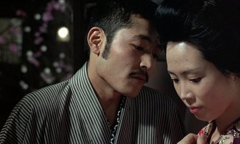 Movie still from “In the Realm of the Senses” (1976), directed by Nagisa Ôshima – A man and a woman looking at one another; Close Up shot, Over the shoulder angle