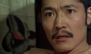 Movie still from “In the Realm of the Senses” (1976), directed by Nagisa Ôshima – A person with a mustache; Close Up shot, High angle