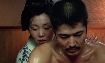 Movie still from “In the Realm of the Senses” (1976), directed by Nagisa Ôshima – A man and a woman in traditional japanese clothing; Close Up shot, High angle
