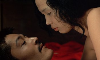Movie still from “In the Realm of the Senses” (1976), directed by Nagisa Ôshima – A man and a woman face to face in the dark; Close Up shot, Overhead angle