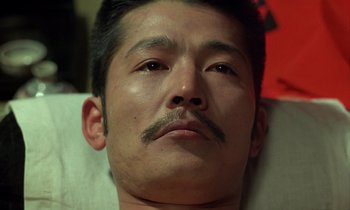Movie still from “In the Realm of the Senses” (1976), directed by Nagisa Ôshima – A person with a mustache; Close Up shot, High angle
