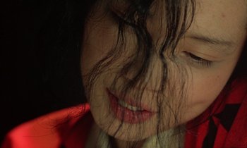 Movie still from “In the Realm of the Senses” (1976), directed by Nagisa Ôshima – A woman's face with hair on her face; Extreme Close Up shot, High angle