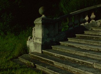Movie still from “India Song” (1975), directed by Marguerite Duras – A stone staircase with a railing in the middle of it; Extreme Wide shot, High angle