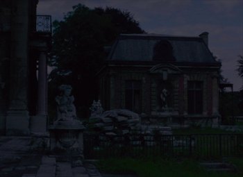 Movie still from “India Song” (1975), directed by Marguerite Duras – A building that has statues in front of it; Extreme Wide shot, Low angle