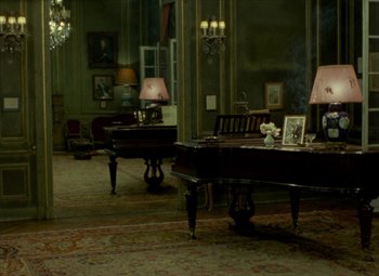 Movie still from “India Song” (1975), directed by Marguerite Duras – A living room with two grand pianos in it; Wide shot, High angle