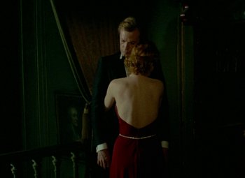 Movie still from “India Song” (1975), directed by Marguerite Duras – A man and a woman standing next to each other in a room; Medium shot, Over the shoulder angle
