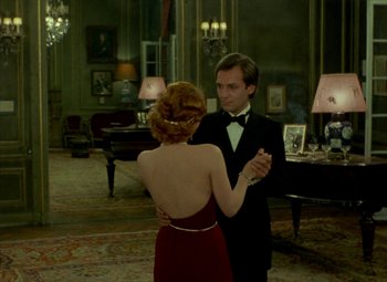 Movie still from “India Song” (1975), directed by Marguerite Duras – A man and a woman dancing in front of a mirror; Medium shot, High angle