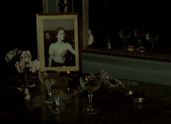 Movie still from “India Song” (1975), directed by Marguerite Duras – A picture of a woman in front of a picture of herself; Medium shot, High angle