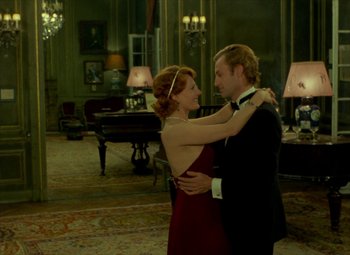 Movie still from “India Song” (1975), directed by Marguerite Duras – A man and a woman dancing in front of a grand piano; Medium shot, Over the shoulder angle