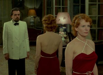 Movie still from “India Song” (1975), directed by Marguerite Duras – A man and two women standing in front of each other; Medium shot, Over the shoulder angle