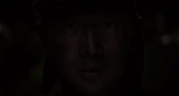 Movie still from “Indignation” (2016), directed by James Schamus – A person's face in the dark; Extreme Close Up shot, Over the shoulder angle
