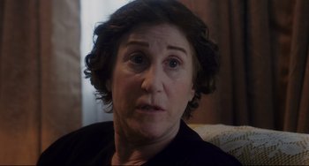 Movie still from “Indignation” (2016), directed by James Schamus – A person sitting on a couch; Close Up shot, Over the shoulder angle