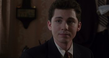 Movie still from “Indignation” (2016), directed by James Schamus – A man in a suit and tie looking at the camera; Close Up shot, High angle