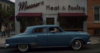 Movie still from “Indignation” (2016), directed by James Schamus – An old car parked in front of a meat & poultry restaurant; Wide shot, Low angle