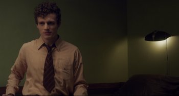 Movie still from “Indignation” (2016), directed by James Schamus – A man in a brown shirt and a brown neck tie; Medium shot, Low angle