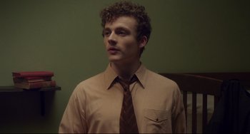 Movie still from “Indignation” (2016), directed by James Schamus – A man in a brown shirt and a brown tie; Close Up shot, Low angle