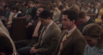 Movie still from “Indignation” (2016), directed by James Schamus – A group of people sitting in a church; Medium shot, High angle