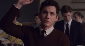 Movie still from “Indignation” (2016), directed by James Schamus – A man in a brown sweater and a tie; Medium shot, High angle