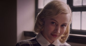 Movie still from “Indignation” (2016), directed by James Schamus – A woman with blonde hair wearing a dress shirt and tie; Close Up shot, Over the shoulder angle