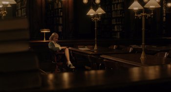 Movie still from “Indignation” (2016), directed by James Schamus – A woman sitting at a table in a library; Wide shot, High angle