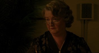 Movie still from “Indignation” (2016), directed by James Schamus – An older woman wearing glasses looking at the camera; Close Up shot, Over the shoulder angle