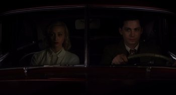 Movie still from “Indignation” (2016), directed by James Schamus – A man and a woman sitting in the back of a car; Medium shot, Low angle