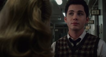 Movie still from “Indignation” (2016), directed by James Schamus – A man in a vest and tie looking at a woman in a plaid vest; Close Up shot, Over the shoulder angle