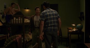 Movie still from “Indignation” (2016), directed by James Schamus – Two young men standing next to each other in front of a mirror; Medium shot, Over the shoulder angle