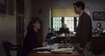 Movie still from “Indignation” (2016), directed by James Schamus – A woman and a man are sitting at a desk; Medium shot, Over the shoulder angle
