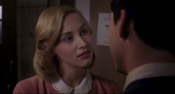 Movie still from “Indignation” (2016), directed by James Schamus – A woman with blonde hair and a pink dress is looking at a man; Close Up shot, Over the shoulder angle