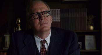Movie still from “Indignation” (2016), directed by James Schamus – An older man wearing a suit and tie; Close Up shot, Over the shoulder angle