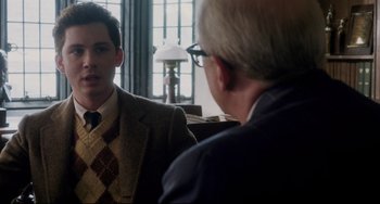Movie still from “Indignation” (2016), directed by James Schamus – A man in a suit is talking to another man in a suit; Medium shot, Over the shoulder angle