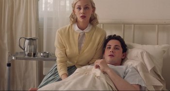 Movie still from “Indignation” (2016), directed by James Schamus – A man and a woman sitting in a hospital bed; Medium shot, High angle