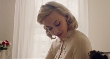 Movie still from “Indignation” (2016), directed by James Schamus – A woman with blonde hair is looking down at her face; Close Up shot, High angle