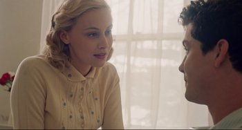 Movie still from “Indignation” (2016), directed by James Schamus – A young woman talking to a young man in front of a window; Close Up shot, Over the shoulder angle