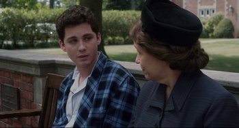 Movie still from “Indignation” (2016), directed by James Schamus – A man and a woman sitting next to each other on a park bench; Medium shot, Over the shoulder angle