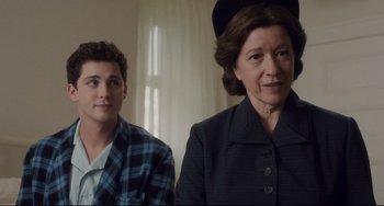 Movie still from “Indignation” (2016), directed by James Schamus – A woman and a boy are sitting in a living room; Medium shot, Over the shoulder angle