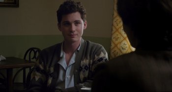 Movie still from “Indignation” (2016), directed by James Schamus – A young man sitting at a table with a cup of coffee; Close Up shot, Over the shoulder angle