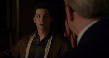 Movie still from “Indignation” (2016), directed by James Schamus – A young man looking into a mirror while standing next to an older man; Medium shot, Over the shoulder angle