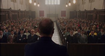 Movie still from “Indignation” (2016), directed by James Schamus – A large group of people sitting in front of an audience; Wide shot, High angle
