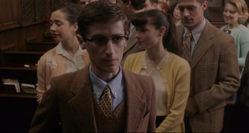 Movie still from “Indignation” (2016), directed by James Schamus – A group of people standing in a room; Medium shot, Over the shoulder angle