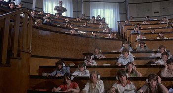 Movie still from “Inferno” (1980), directed by Dario Argento – A group of people sitting in a lecture hall; Wide shot, High angle
