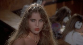 Movie still from “Inferno” (1980), directed by Dario Argento – A beautiful woman with long hair and a necklace; Close Up shot, High angle