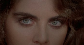 Movie still from “Inferno” (1980), directed by Dario Argento – A woman's eyes with blue eyes; Extreme Close Up shot, Over the shoulder angle