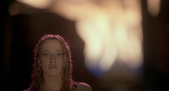 Movie still from “Inferno” (1980), directed by Dario Argento – A woman with red curly hair is looking at the camera; Close Up shot, Low angle