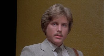 Movie still from “Inferno” (1980), directed by Dario Argento – A person wearing a suit and tie; Close Up shot, Low angle