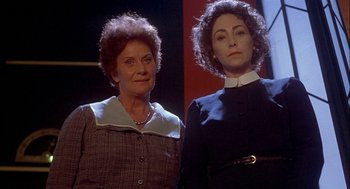 Movie still from “Inferno” (1980), directed by Dario Argento – Two women standing next to each other on a stage; Medium shot, Low angle