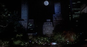 Movie still from “Inferno” (1980), directed by Dario Argento – A full moon rises over a city at night; Extreme Wide shot, High angle