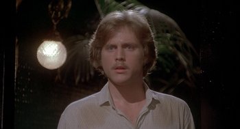 Movie still from “Inferno” (1980), directed by Dario Argento – A man in a white shirt is in front of a tree; Close Up shot, Low angle